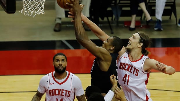 May 14, 2021; Houston, Texas, USA; LA Clippers center Serge Ibaka (9) drives to the basket as Houston Rockets forward Kelly Olynyk (41) defends during the first quarter at Toyota Center. Mandatory Credit: Bob Levey/Pool Photo-USA TODAY Sports